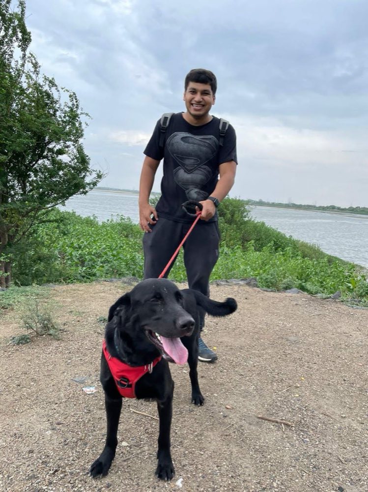 Harsh with a black Labrador on a lakeside trail